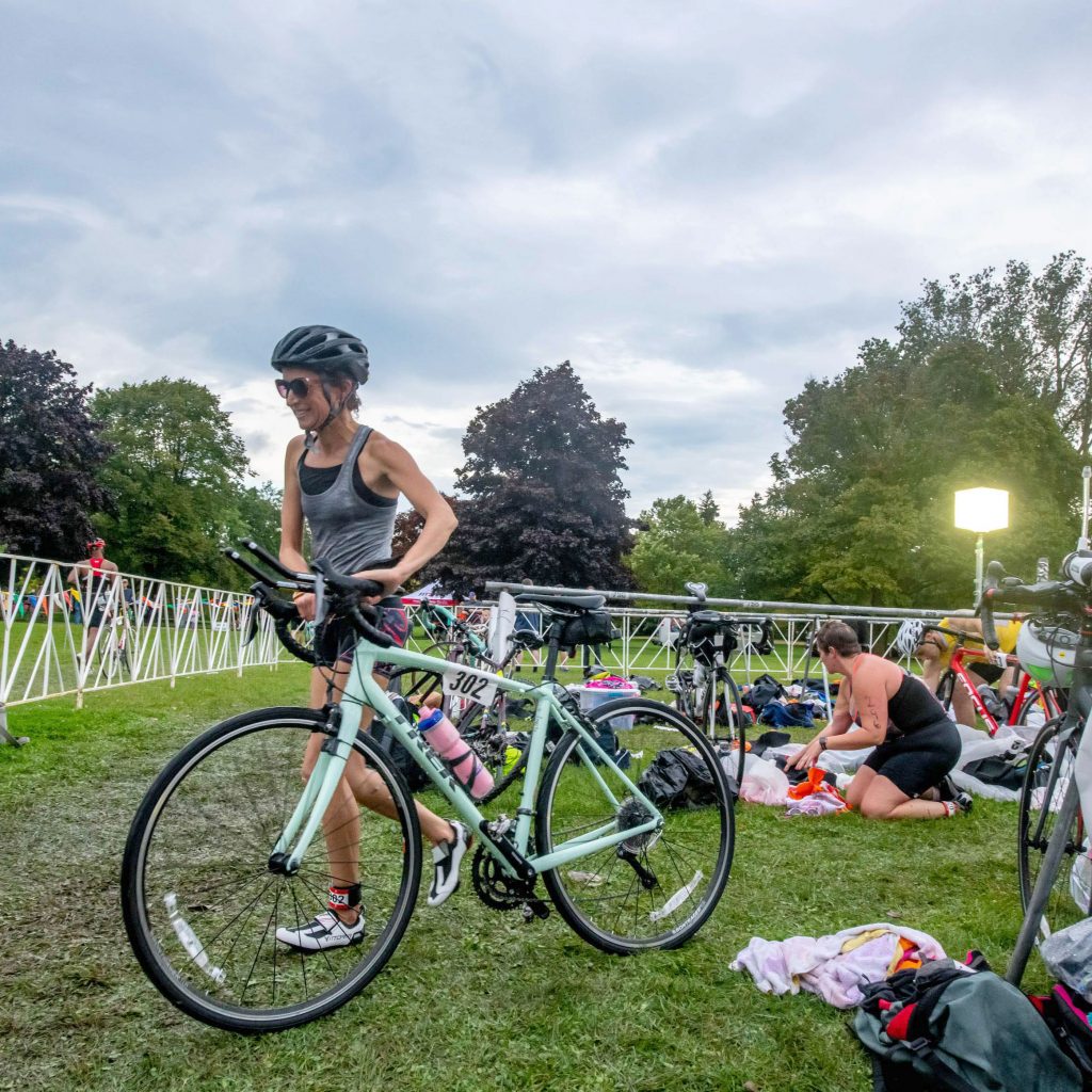 Person exiting the transition area with their bike.